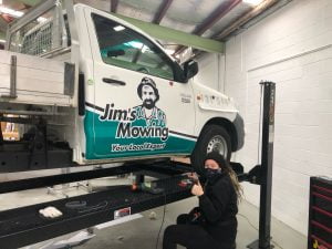 Jims Mowing franchise branding on 2 door ute